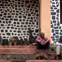 Mission Bandja. les serviteurs du chef assis sur les marches du palais colonial © Estelle Vanneste